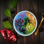 mixed fruits on bowl with blueberry on top